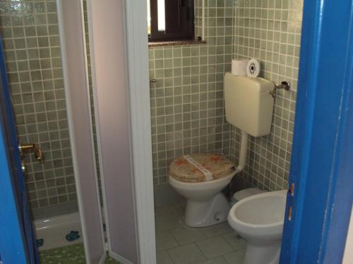 a bathroom with a toilet and a sink at Villa La Spada in Taormina
