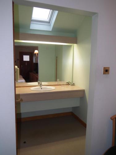 a bathroom with a sink and a mirror at The Red Lion Tavern in Fochabers