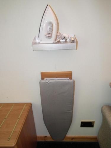 a bathroom with a toilet with a shelf on the wall at The Red Lion Tavern in Fochabers