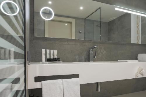 a bathroom with a sink and a mirror at The Legacy Luxury Hotel, Algiers in Alger