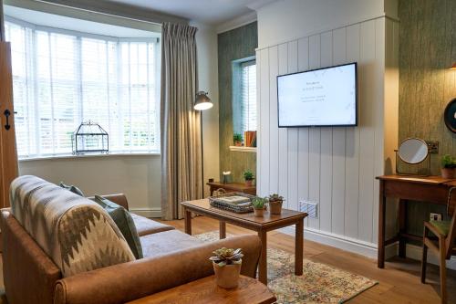 a living room with a couch and a flat screen tv at Middletons in York