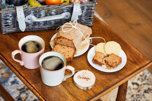 a table with two cups of coffee and bread at Middletons in York