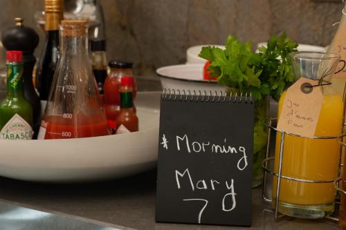 a sign that says a not mindingmamary next to bottles of drinks at The Legacy Luxury Hotel, Algiers in Alger