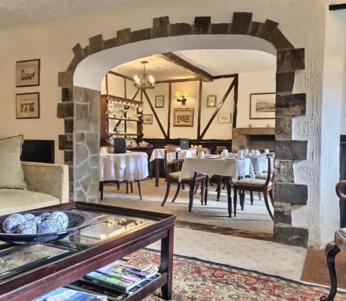 a dining room with white tables and chairs at Grove House in Leyburn