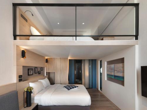 a bedroom with a bed in a loft at Explore Hotel in Taichung