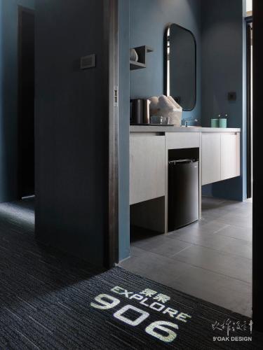 a bathroom with a sink and a mirror at Explore Hotel in Taichung