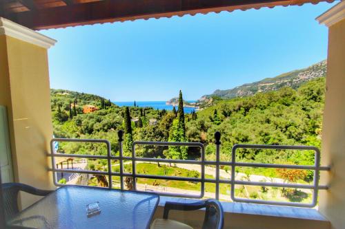 a room with a balcony with a view of the ocean at Avra Sunset Sea View Liapades in Liapades