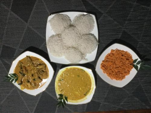 four bowls of different types of food on a table at Kandyan Lounge in Kiribatkumbura