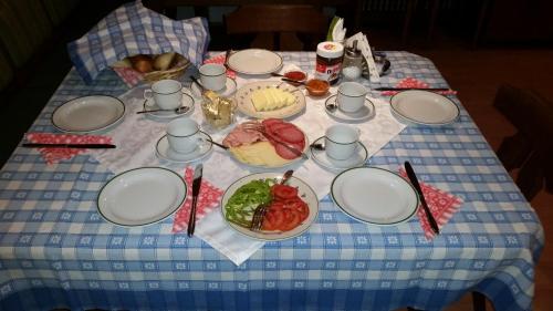 a table with plates and bowls of food on it at Huberhof im Almenland in Sankt Kathrein am Offenegg