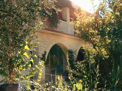a brick oven in the middle of a garden at Apartments Ruby in Funtana