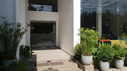 a patio with potted plants in front of a building at Pinnacle boutique villas in Galle