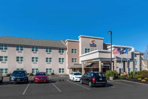 a hotel with cars parked in a parking lot at Comfort Inn & Suites Northern Kentucky in Wilder