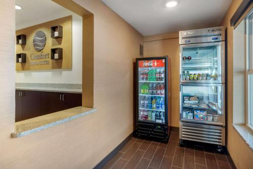 a refrigerator filled with drinks in a room at Comfort Inn & Suites Northern Kentucky in Wilder