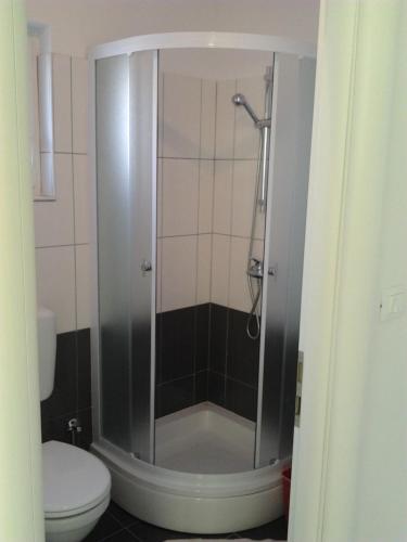 a shower stall in a bathroom with a toilet at Vita Style in Kaštela