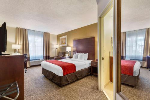 a hotel room with a large bed and a television at Comfort Inn Auburn-Worcester in Auburn