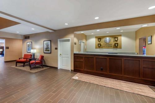 a large lobby with a waiting room with a desk and chairs at Comfort Inn & Suites Northern Kentucky in Wilder