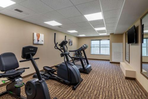 a fitness room with exercise bikes and a flat screen tv at Comfort Inn & Suites Northern Kentucky in Wilder