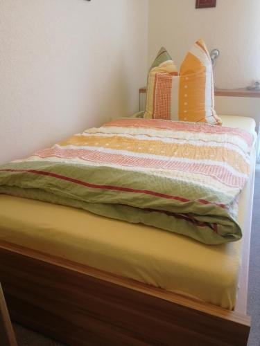 a bedroom with a bed with a yellow mattress at Gästehaus Bausch in Mehring