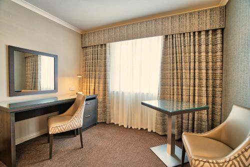 a hotel room with a desk and a window at Inverness Palace Hotel & Spa, WorldHotels Distinctive in Inverness