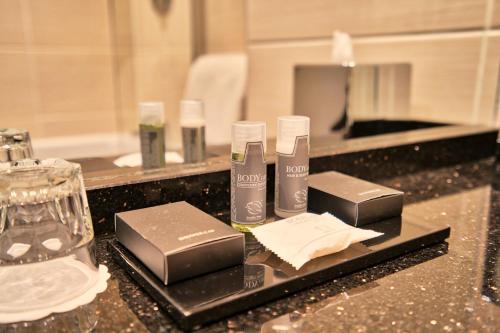 a bathroom counter with two bottles ofodorizers on it at Inverness Palace Hotel & Spa, WorldHotels Distinctive in Inverness
