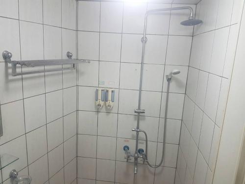 a bathroom with a shower with a glass door at Ming Yang B&B in Fenchihu