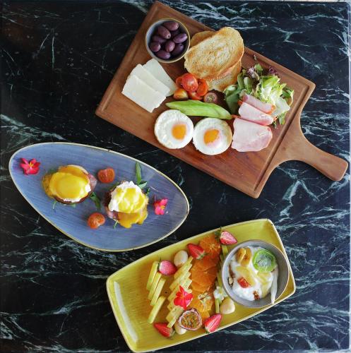 a table with two plates of food with eggs and bread at Polis 1907 by Louis Hotels in Polis Chrysochous