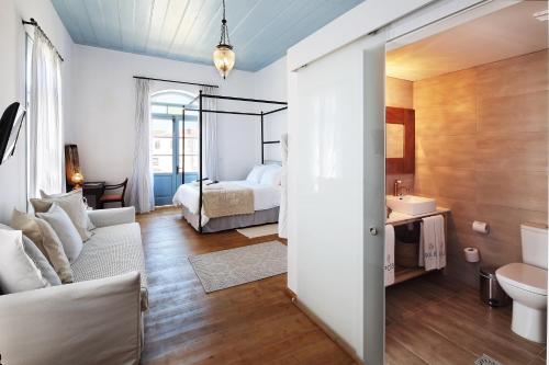 a living room with a couch and a bed at Polis 1907 by Louis Hotels in Polis Chrysochous