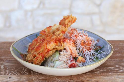 a bowl of food on a wooden table at Polis 1907 by Louis Hotels in Polis Chrysochous