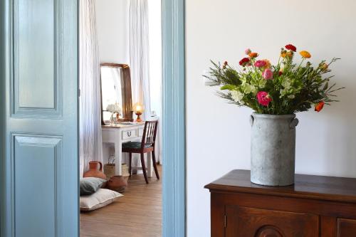 a vase of flowers sitting on top of a table at Polis 1907 by Louis Hotels in Polis Chrysochous