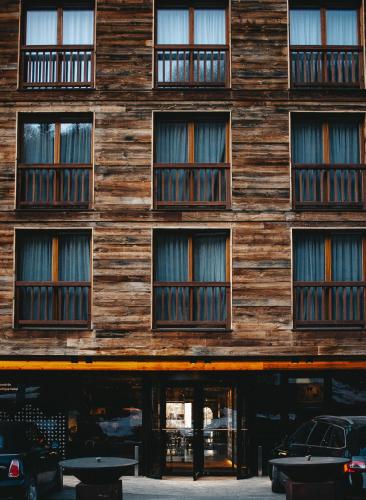 a wooden building with many windows on it at Chandolin Boutique Hotel in Chandolin