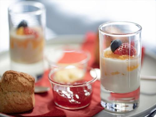 a tray with two glasses of desserts and a piece of bread at UNWIND HOTEL & BAR OTARU in Otaru