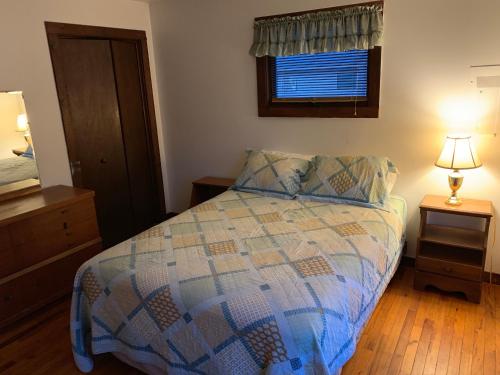 a small bedroom with a bed and a window at Echo Valley Cottages in Coolbaugh