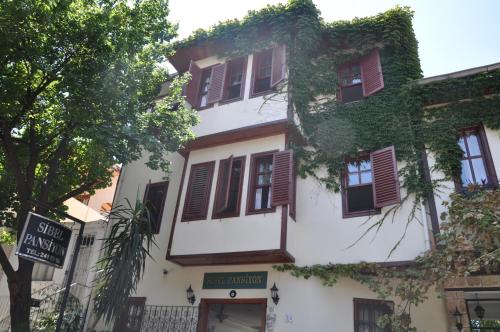 a building with ivy growing on the side of it at Sibel Hotel in Antalya