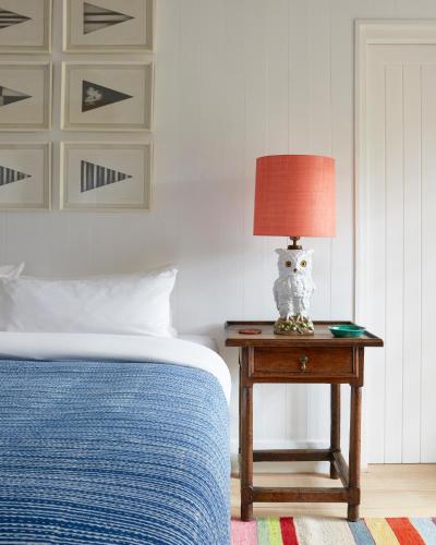 a bedroom with a bed and a table with a lamp at 7 Koppies in Franschhoek