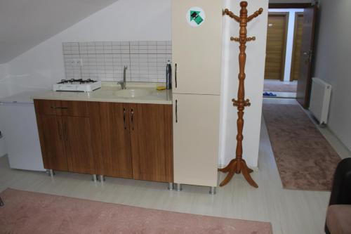 a kitchen with a sink and a refrigerator at Uzungol Selale otel Bungalow in Uzungöl