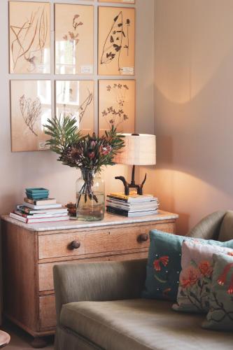 a living room with a couch and a table with books at 7 Koppies in Franschhoek
