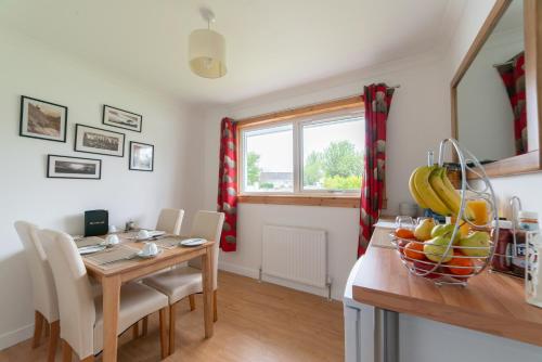 a kitchen and dining room with a table and chairs at No. Three in Stornoway