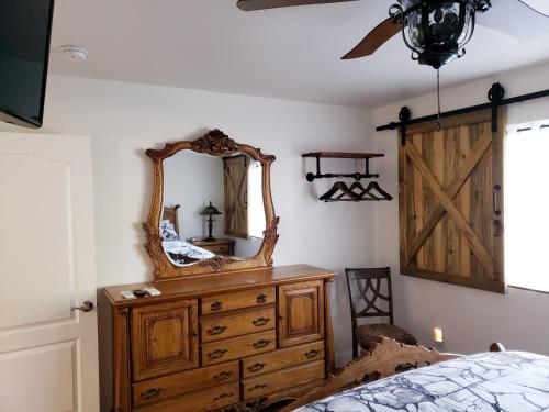 a bedroom with a dresser and a mirror on the wall at Yosemite Foothill Retreat - Private Guest Suite #2 in Coarsegold