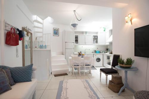 a living room with a couch and a dining room at Homebase in Parikia