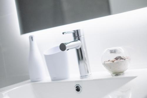 a bathroom sink with a faucet and a bowl on it at GOXUE HOME in Donostia-San Sebastián