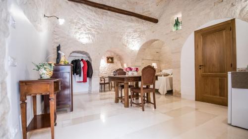 a kitchen and dining room with a table and chairs at Astra in Alberobello