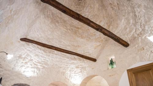 a ceiling with two wooden beams on it at Astra in Alberobello