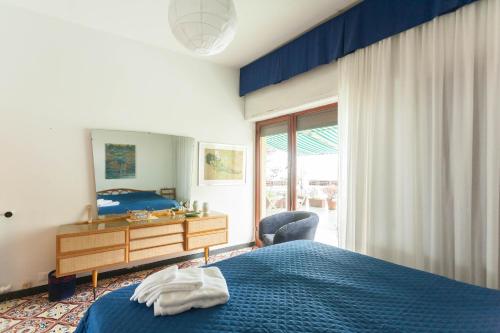 a bedroom with a bed and a dresser and a window at Stunning View- Wifi & Parking in Villa Solari