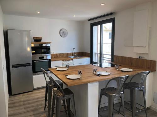 a kitchen with a large wooden table and chairs at Appartement port bonifacio in Bonifacio