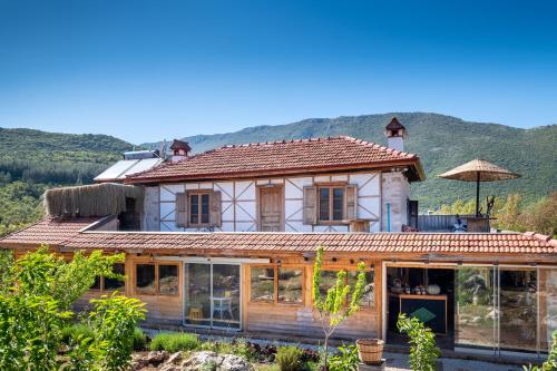 a house with glass doors and a mountain in the background at 3 Oda Kaş in Kas
