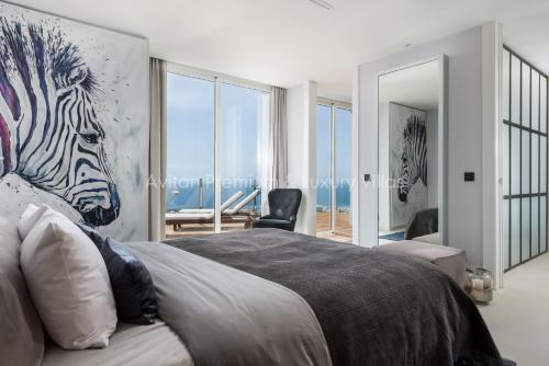 a bedroom with a painting of a zebra on the wall at Avitan Premium & Luxury Villas in Adeje