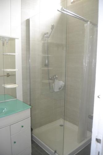 a shower with a glass door in a bathroom at an eol caraibes in Trois-Rivières