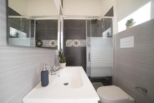 a bathroom with a white sink and a toilet at Peschici HOME FILOCCO stanza e bagno privato in Peschici