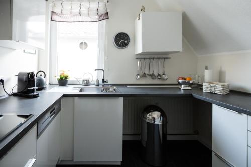 a kitchen with a trash can in the middle of the counter at Glockenstuhl @Conny's in Brilon