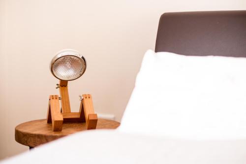 a mirror sitting on a table next to a bed at Glockenstuhl @Conny's in Brilon